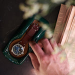 Load image into Gallery viewer, A British Racing Green watch holder with an IWC Pilot&#39;s watch in it sitting on a bedside table
