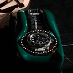 Load image into Gallery viewer, A British Racing Green watch holder with a Rolex Submariner in it sitting on a bedside table
